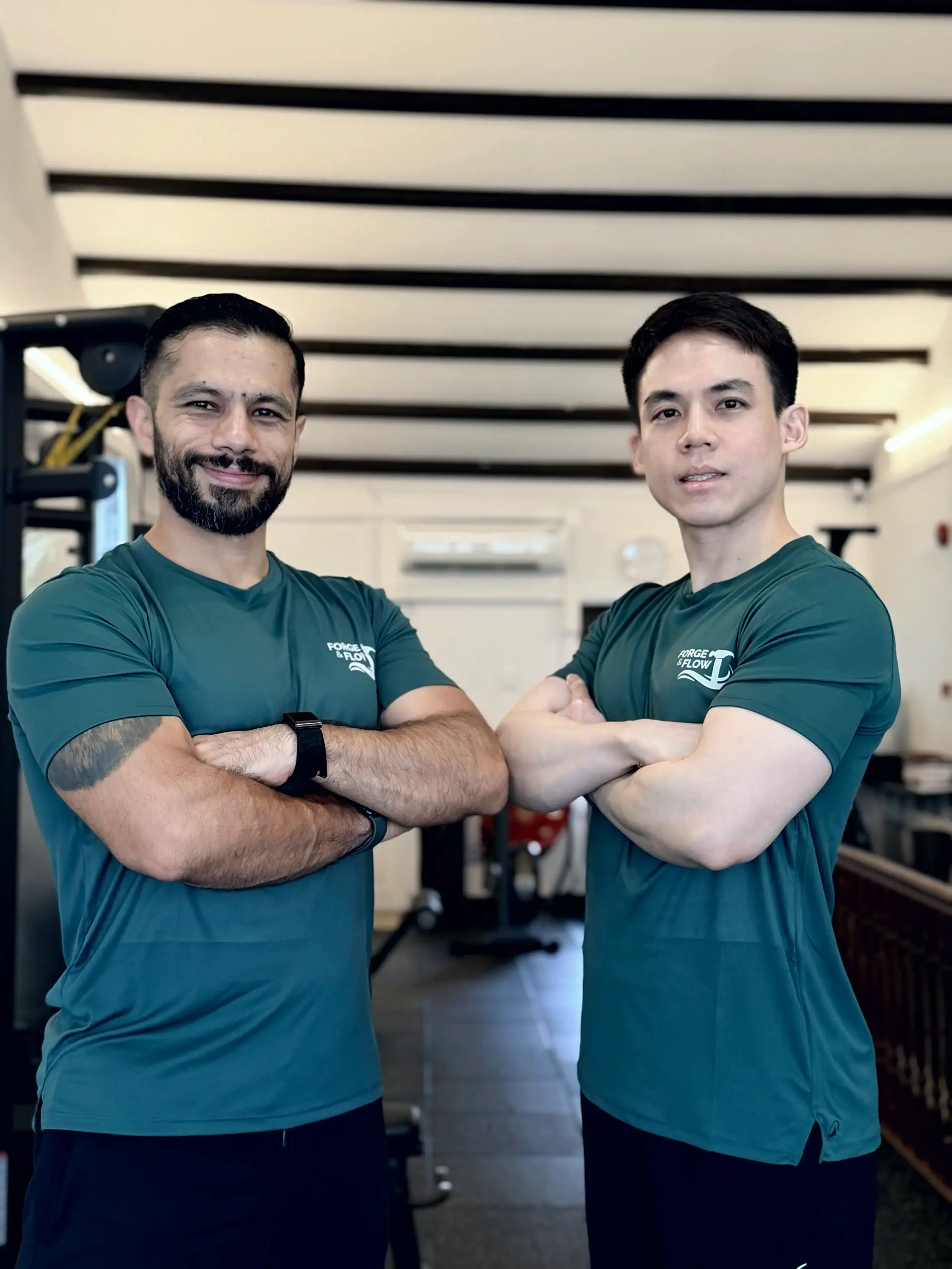 Coaches Ivan Figueroa and Wei Song standing together in the Forge & Flow training space