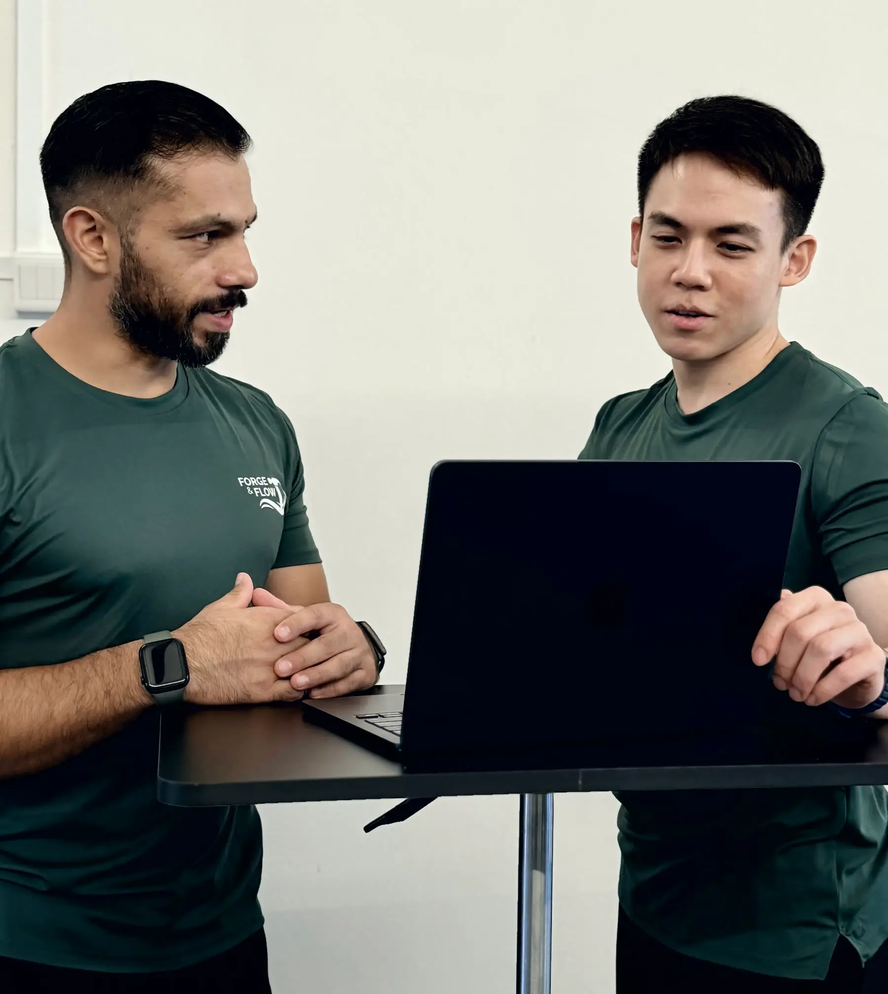 Ivan and Wei Song planning a client programme together at a laptop