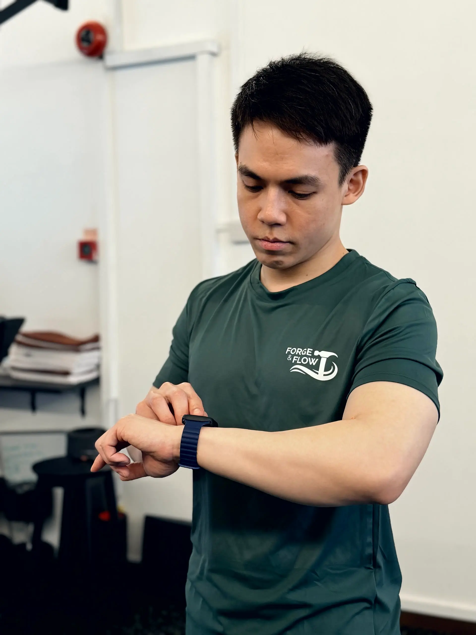 Wei Song, Personal Trainer at Forge & Flow, in the Forge & Flow training shirt